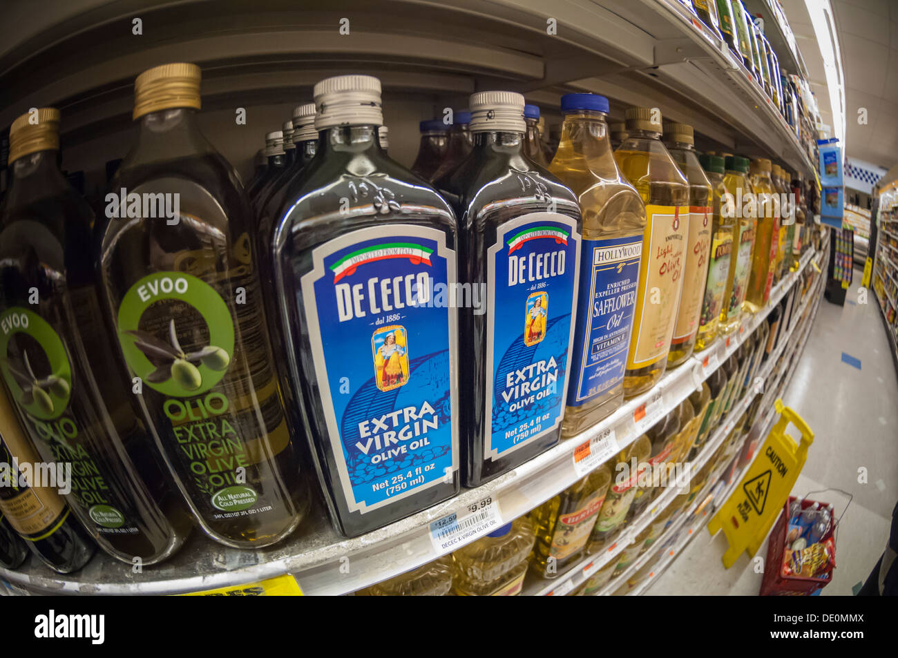 Bottles of imported olive oil are seen on a supermarket shelf in New