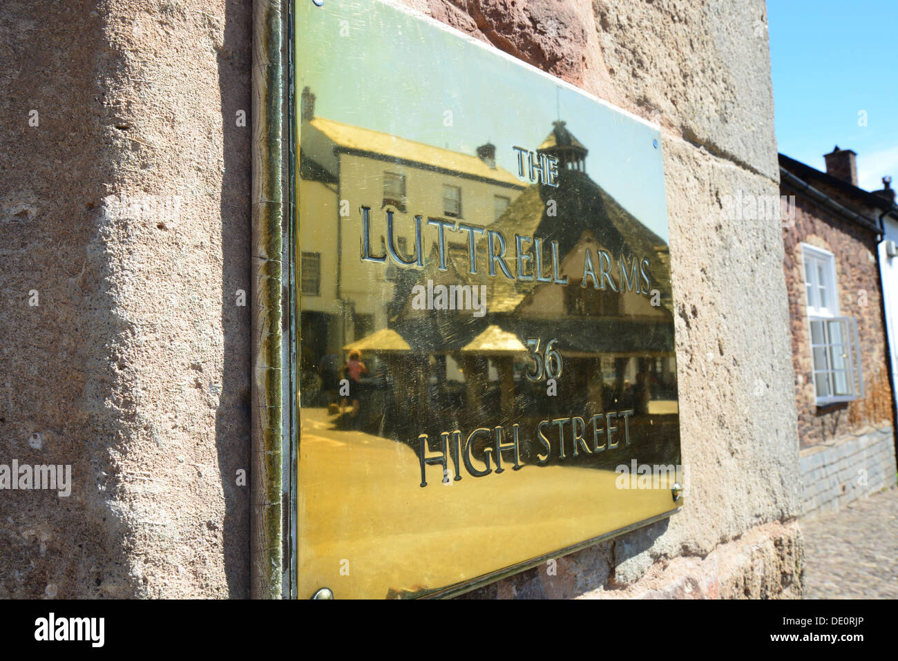 The Yarn Market reflected in The Luttrell Arms plaque, High Street, Dunster, Somerset, England, United Kingdom Stock Photo