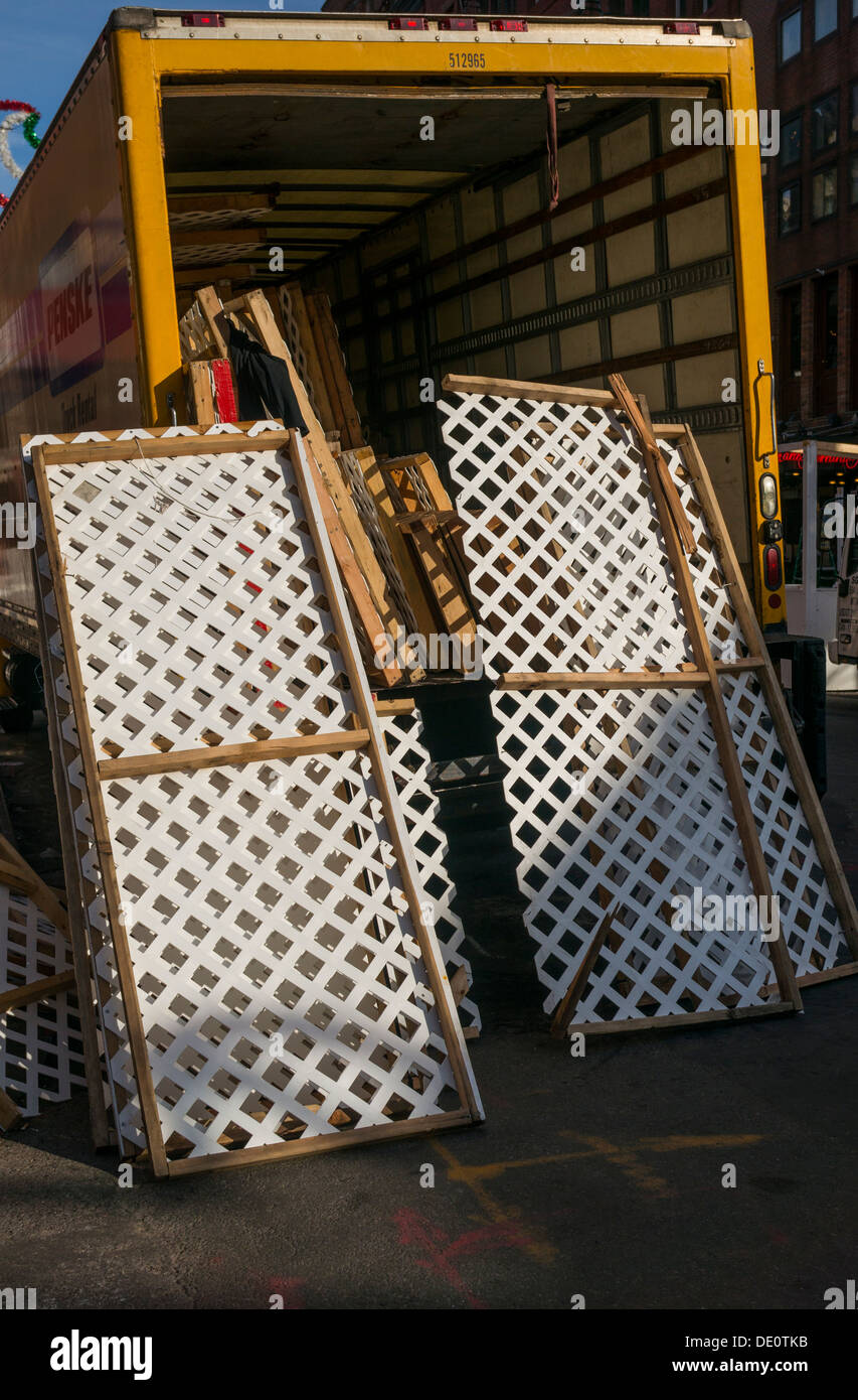 Lattice sections being unloaded from a truck Stock Photo