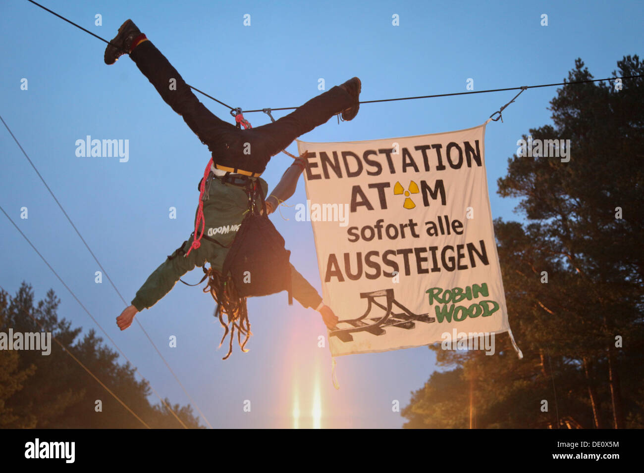 Protest against a nuclear waste transport, an activist of the environmental organization Robin Wood hanging above the transport Stock Photo
