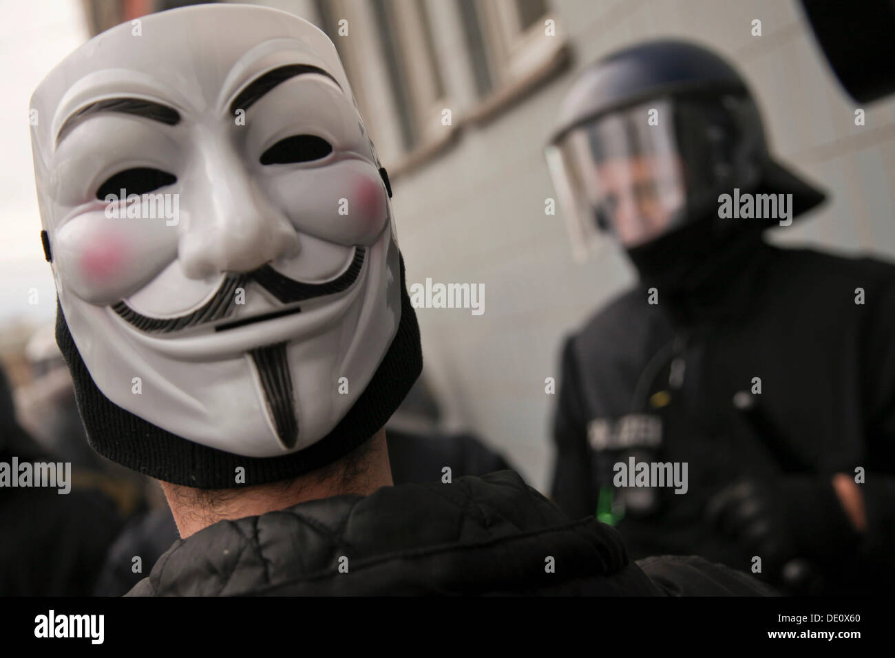 Man wearing a Guy Fawkes mask during a protest against capitalism in