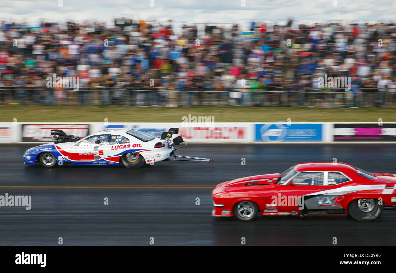 Andy Frost (Nearside) drives the worlds fastest street legal car V Norbert Kuno (far side) driving a Dodge Avenger at Santa Pod. Stock Photo
