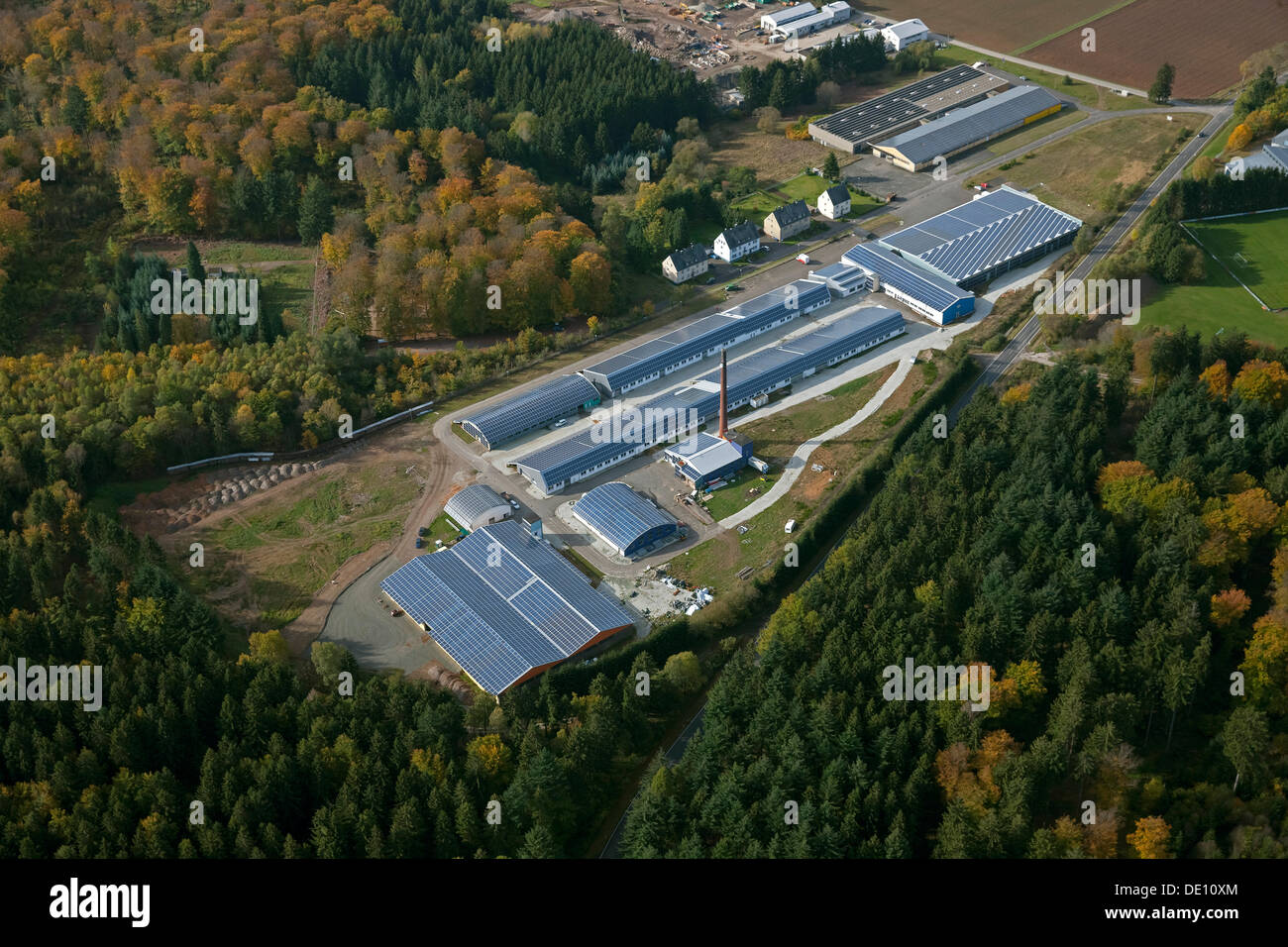 Aerial view, a factory with solar panels on the roof, Grafenwald industrial park, Hunsrueckhoehenstrasse scenic road Stock Photo