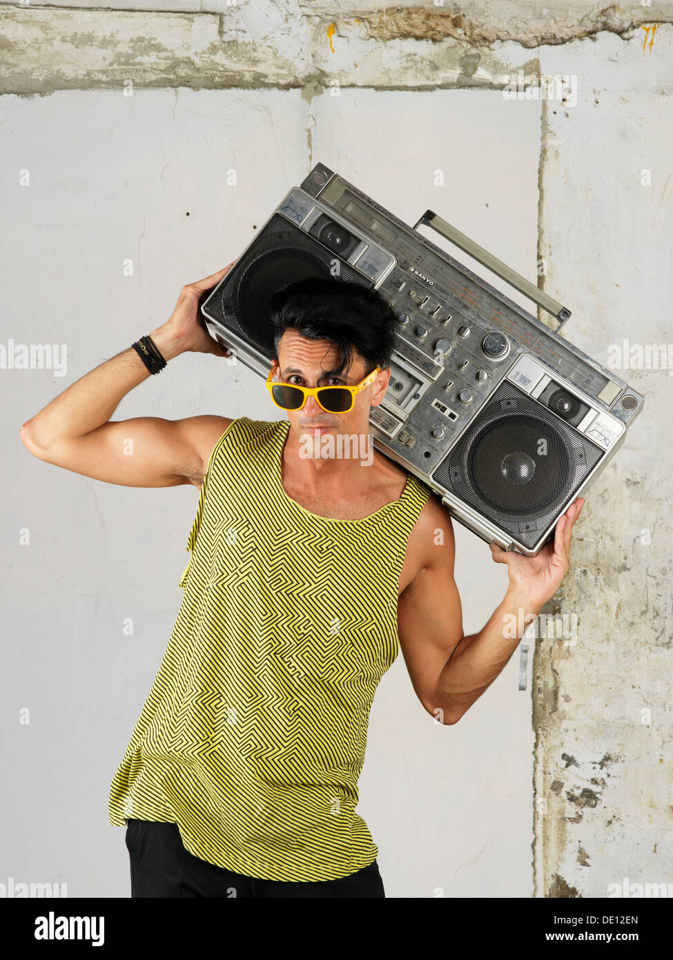 Foolish guy carrying a big portable old radio on his shoulder or on to of  him Stock Photo - Alamy