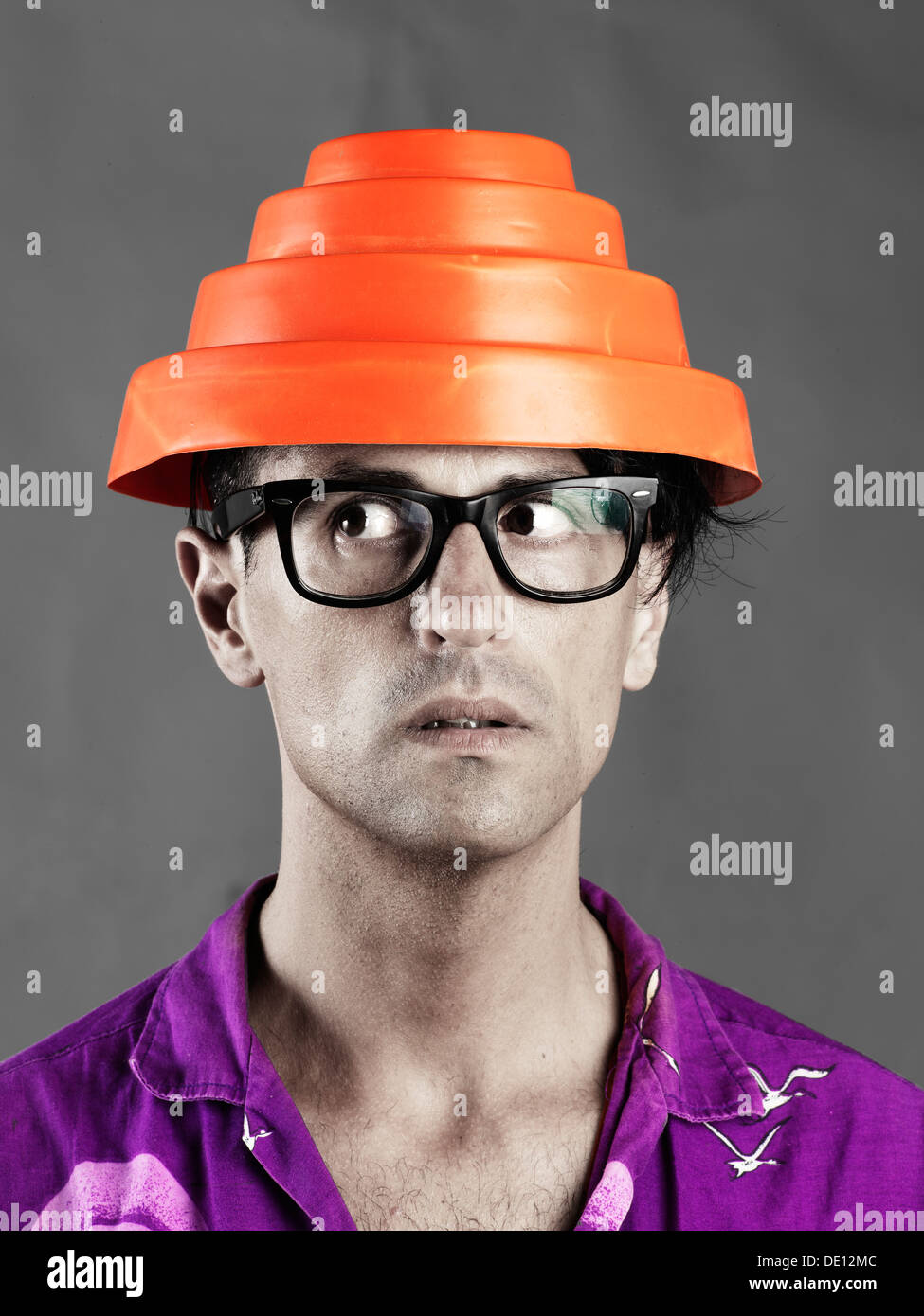 Portrait of a silly guy with a red Devo Energy Dome hat on Stock Photo