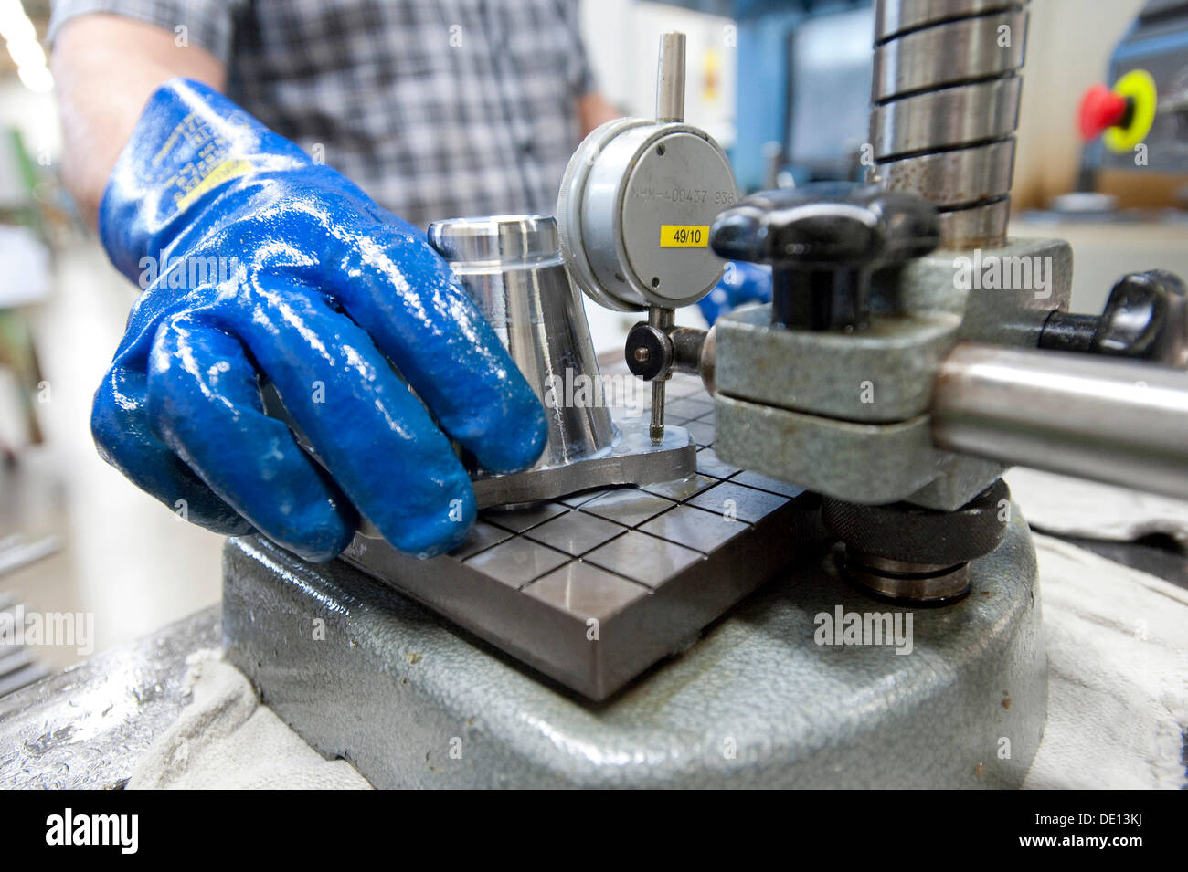 Quality control, measuring with a ruler, machining steel turned parts, GETRAG transmission and drivetrain systems Stock Photo