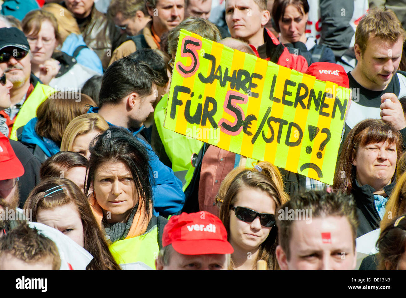 Banner '5 Jahre lernen, fuer 5 Euros pro Stunde', German for 'learn for five years for earning five euros per hour', warning Stock Photo