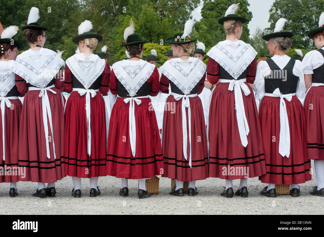 Women in traditional Bavarian costume forming a guard of honour for the entrance into the beer tent, 90th anniversary of the Stock Photo