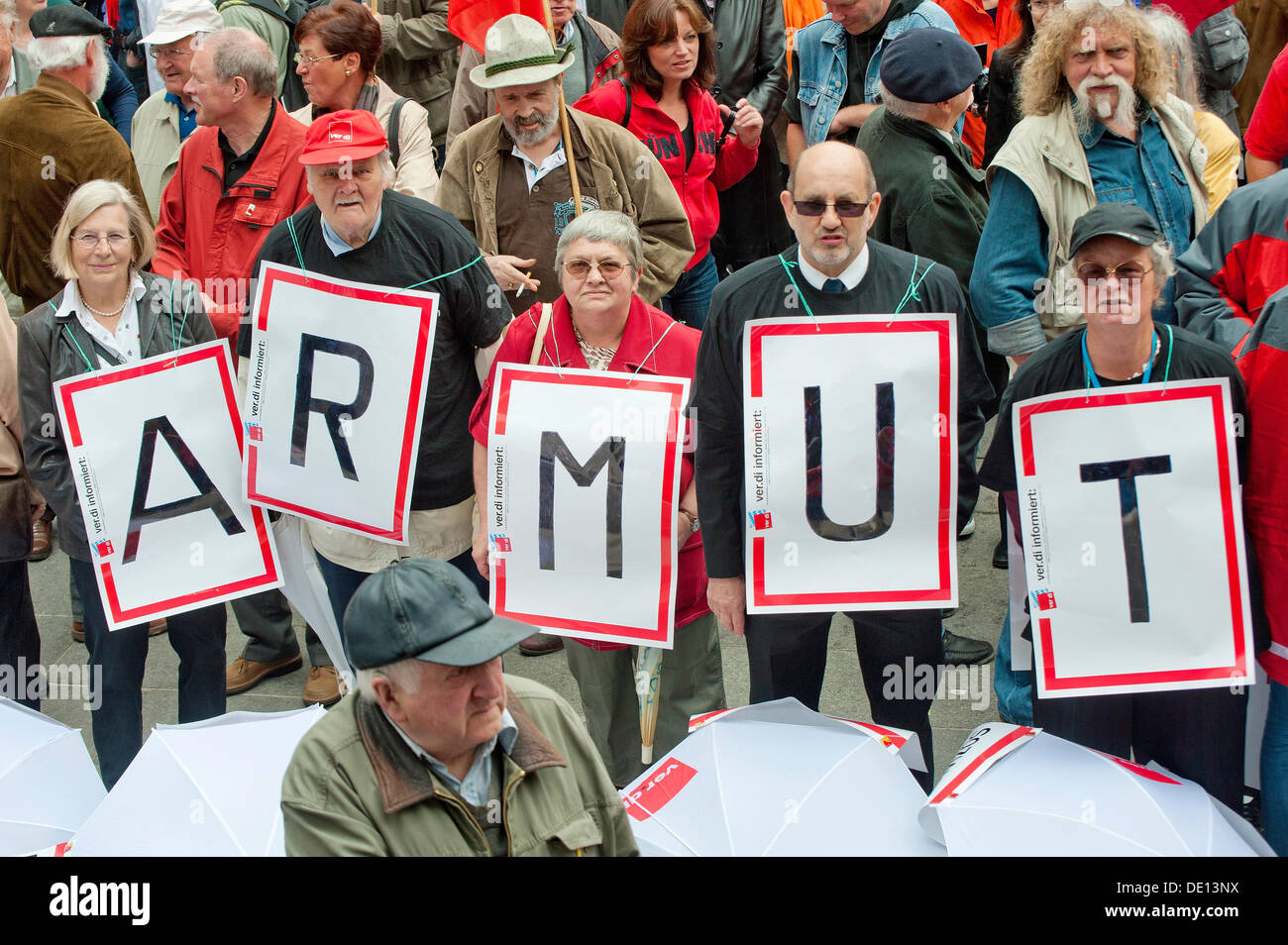 Senior citizens holding protest posters spelling out the word 'Armut', German for 'poverty', trade union rally on 1 May 2011 at Stock Photo