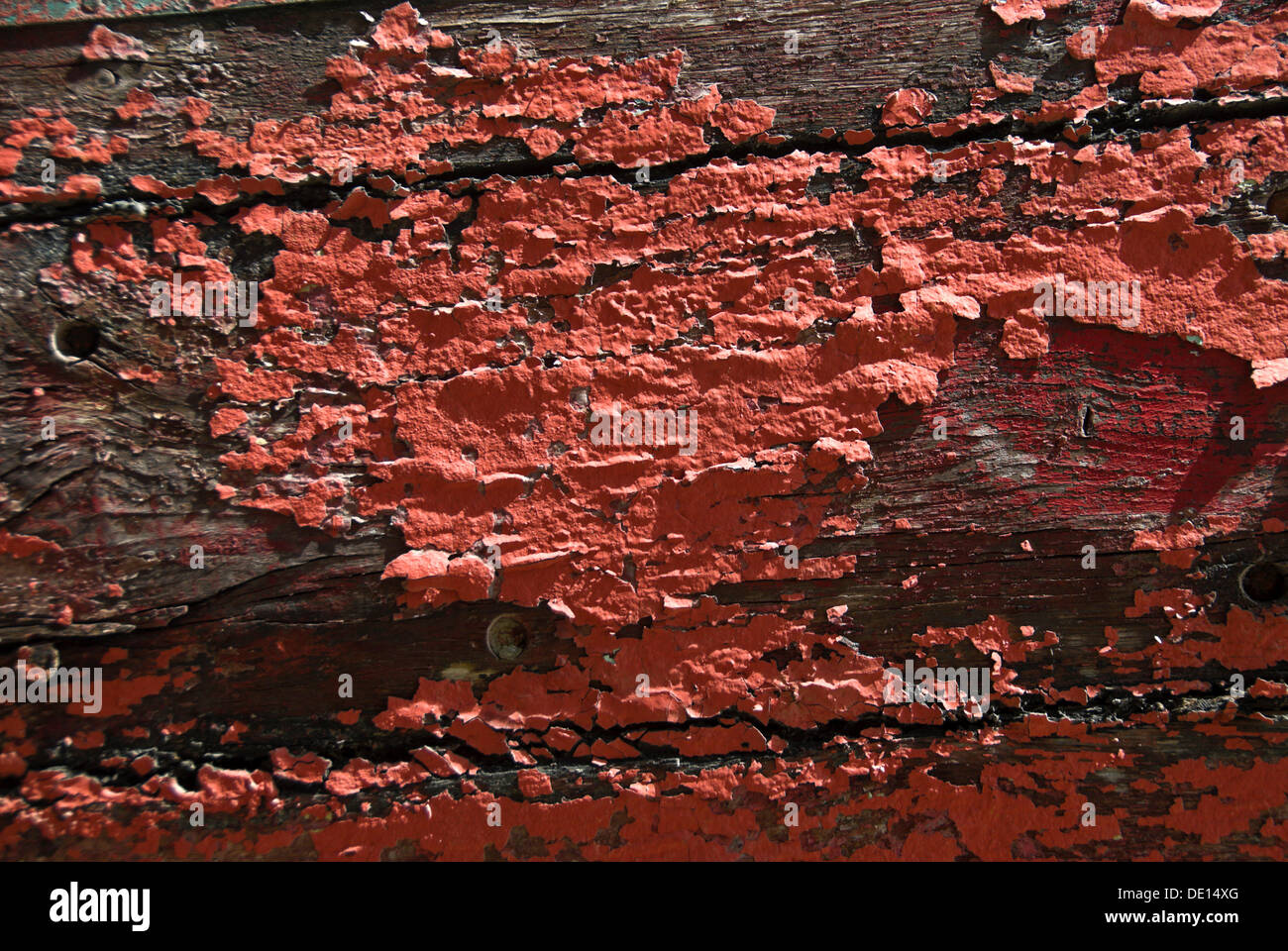 Weathered wooden beams with fragments of red paint, detailed view Stock Photo