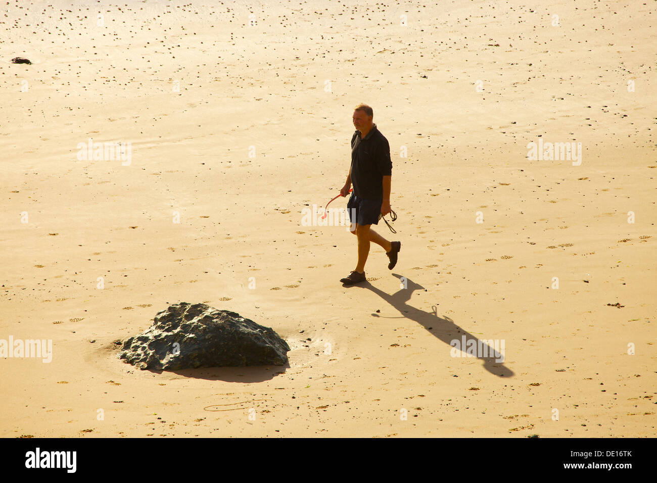 Man walking on the beach hi-res stock photography and images - Alamy