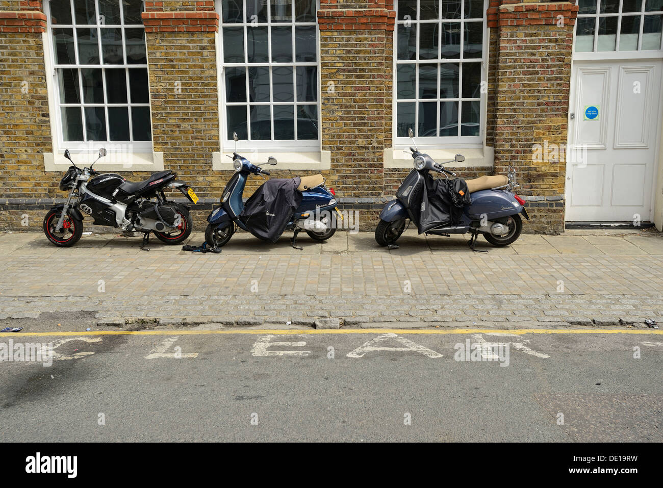 Motorcycles and Scooters parked on the street in London UK Stock Photo Alamy