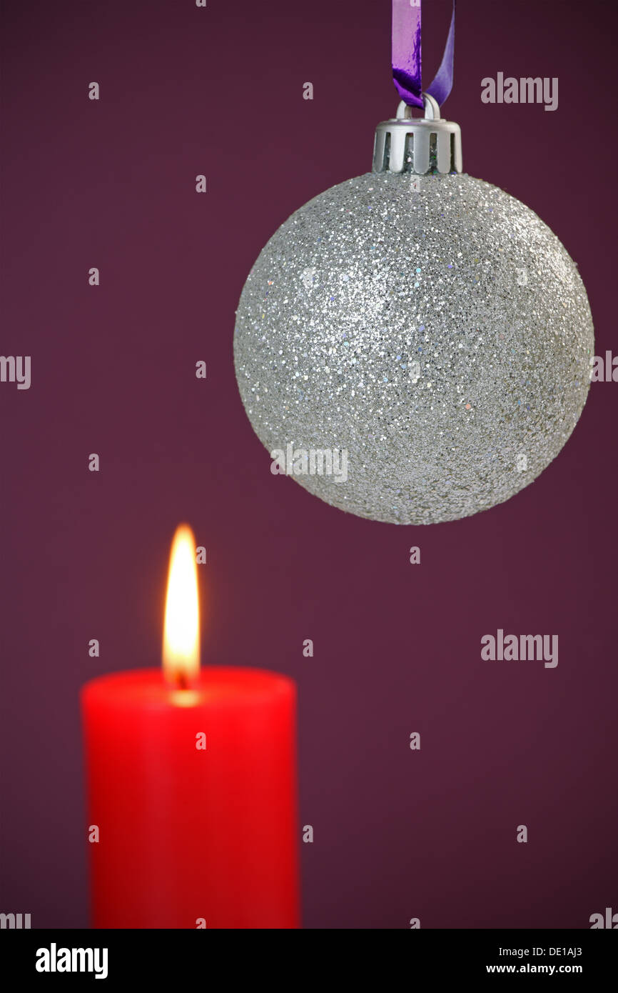 Christmas bauble and lit candle with copy space Stock Photo - Alamy