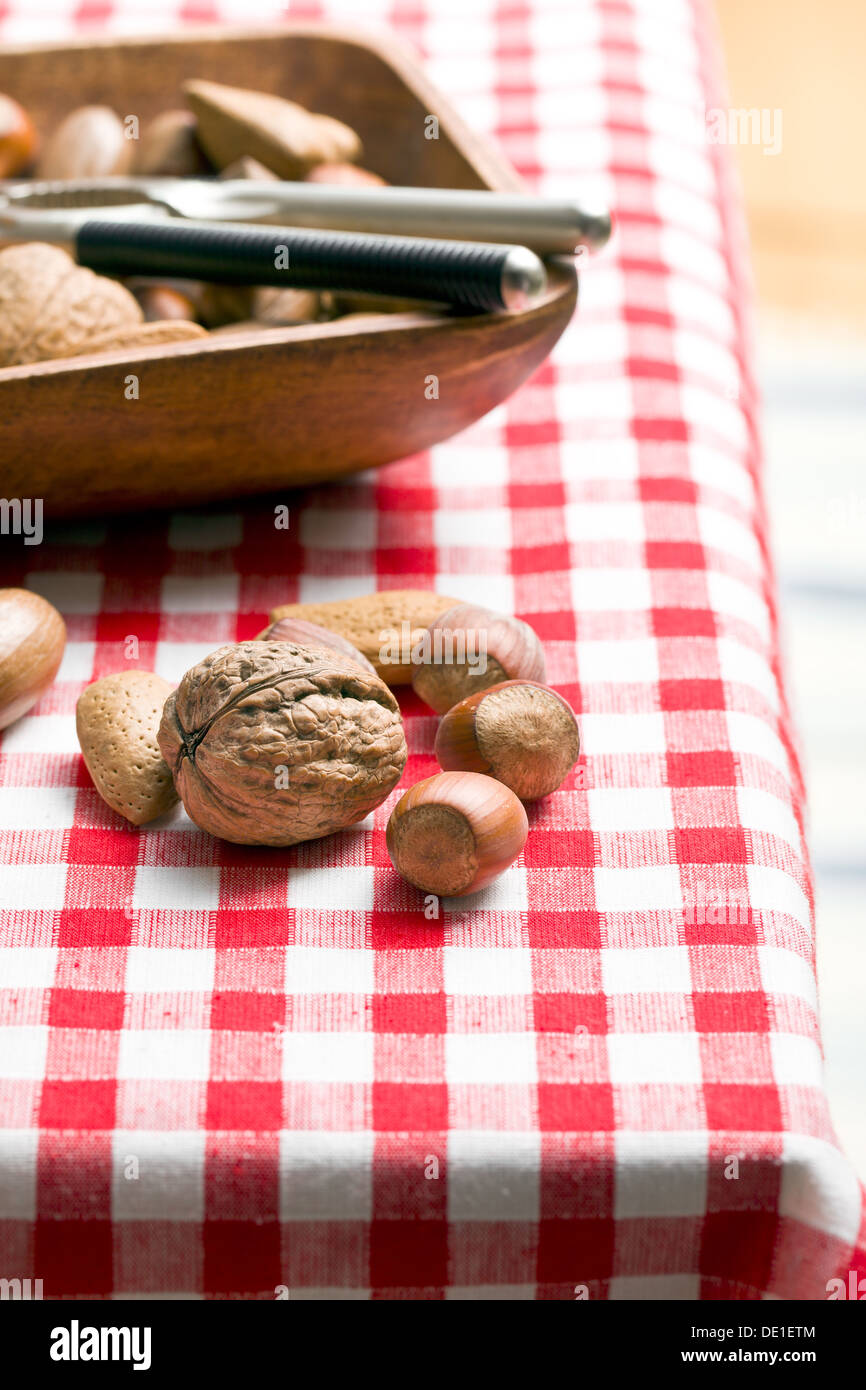 various unpeeled nuts on table Stock Photo