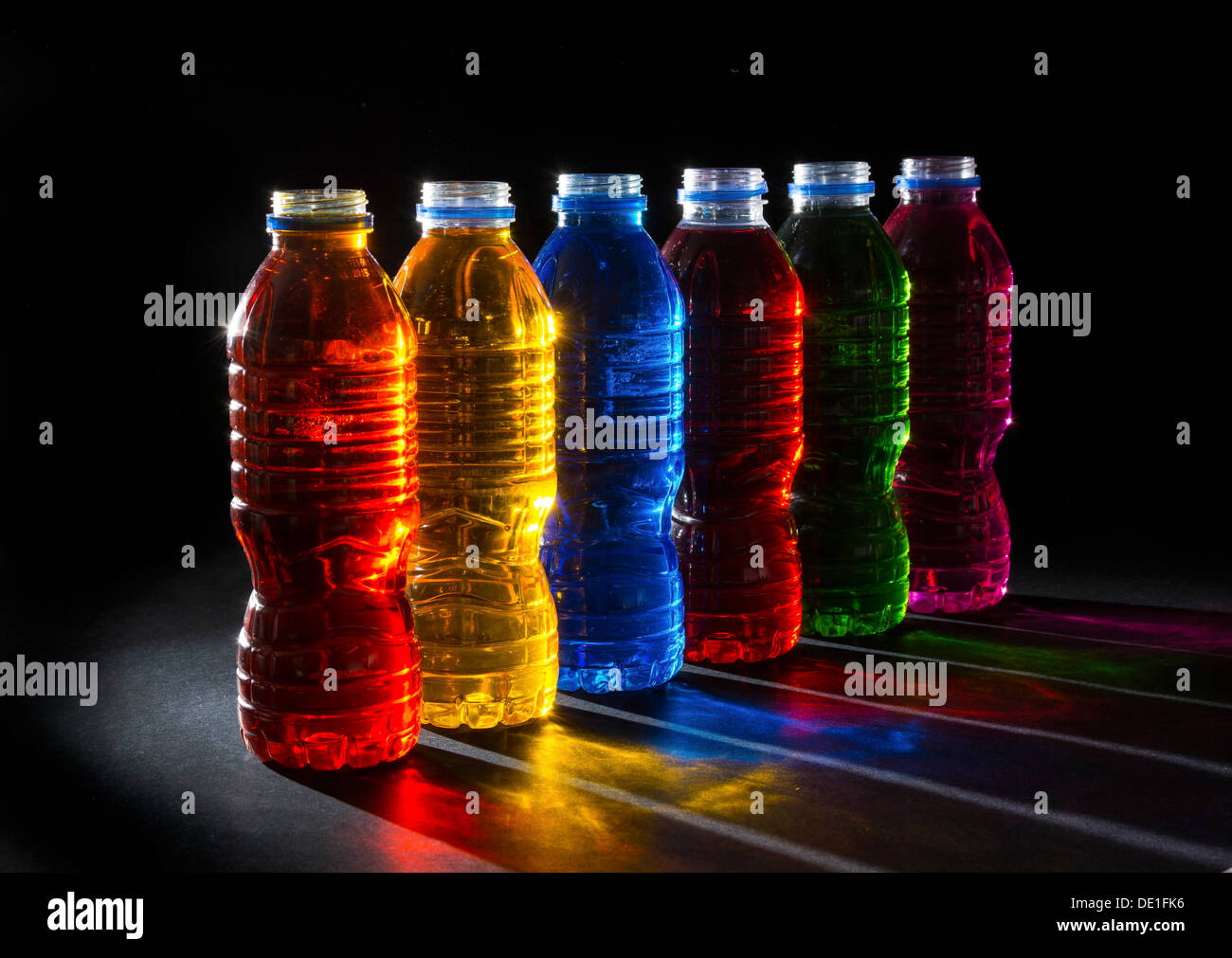 Six coloured backlit bottles Stock Photo