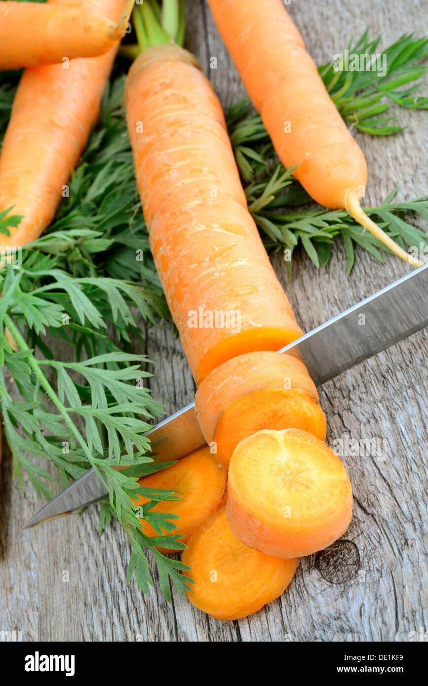 fresh and colorful natural carrots on wooden table Stock Photo