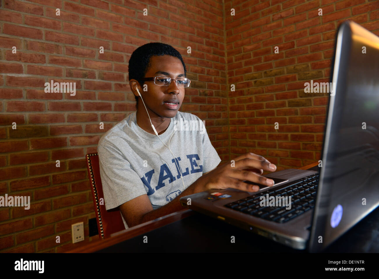 Yale student logs into the Yale network on her computer at Library.He's a pre-medical student. Stock Photo
