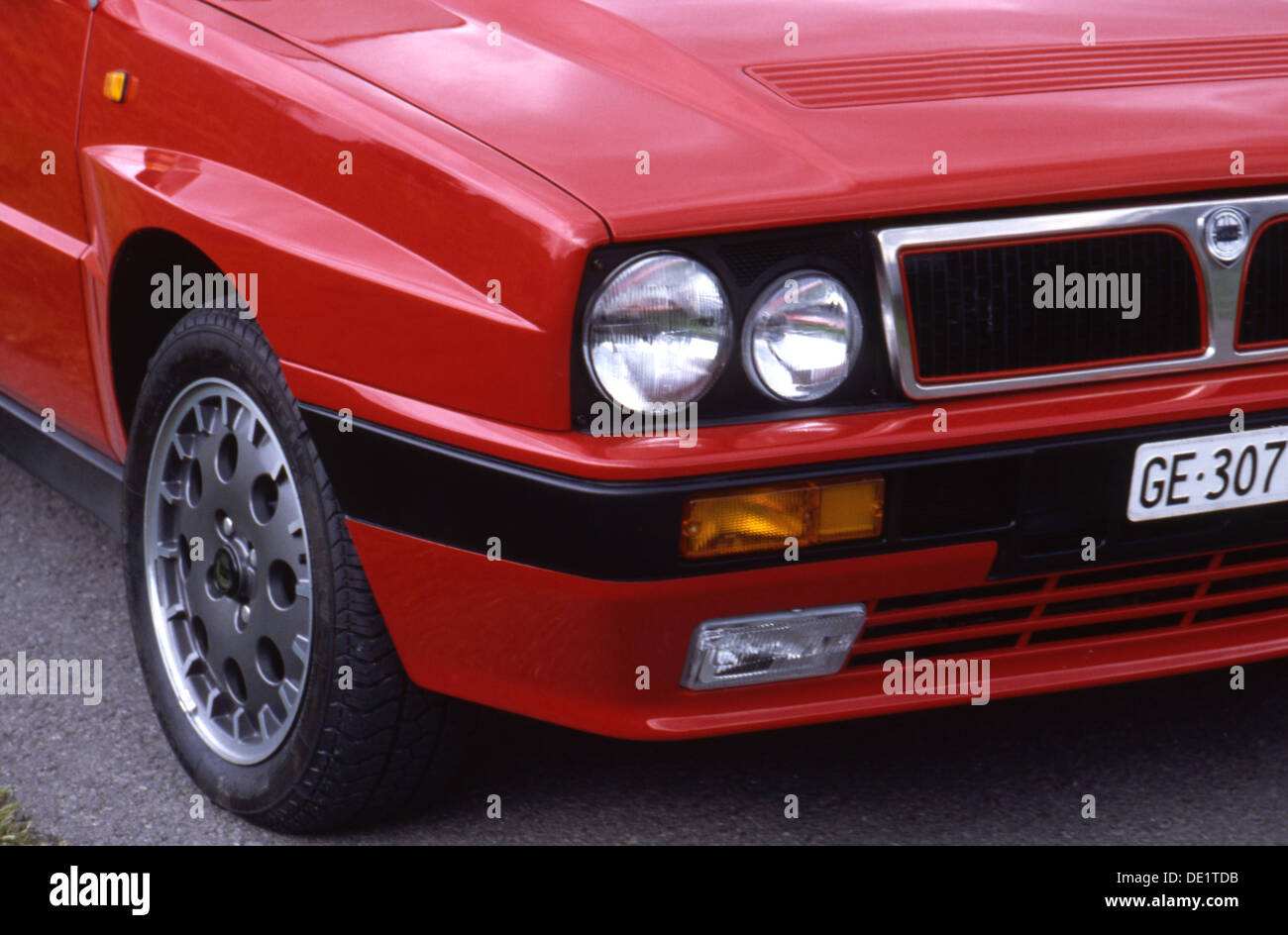Lancia Delta Integrale Sports Car 4x4 4WD 1990s - front grille headlight wheel view in red Stock Photo