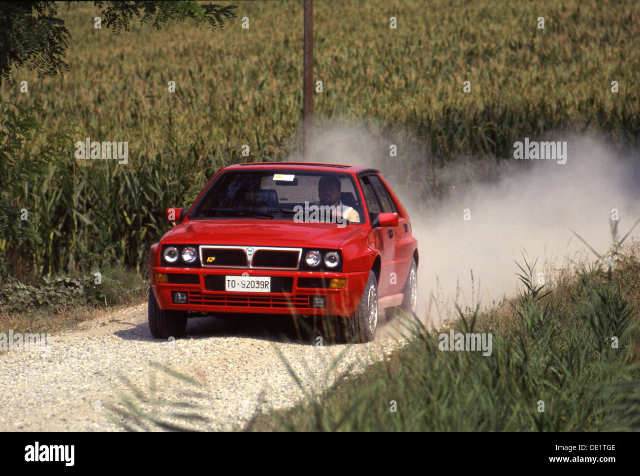 Lancia Delta Integrale HF Sports Car 4x4 4WD 1990s - driving through gravel dust trailling Stock Photo