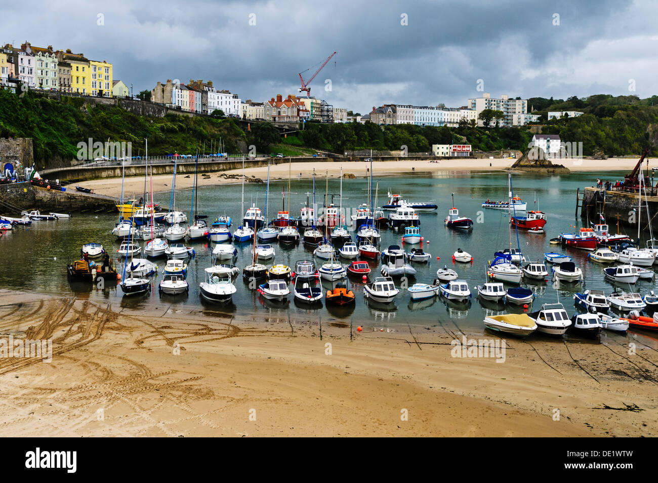 Pastel coloured boarding houses overlook the medieval walls, golden