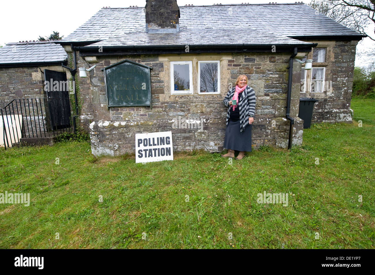 Poll Clerk Karen Holme outside an old rural polling station at Stoke Rivers, Devon during election voting UK Stock Photo