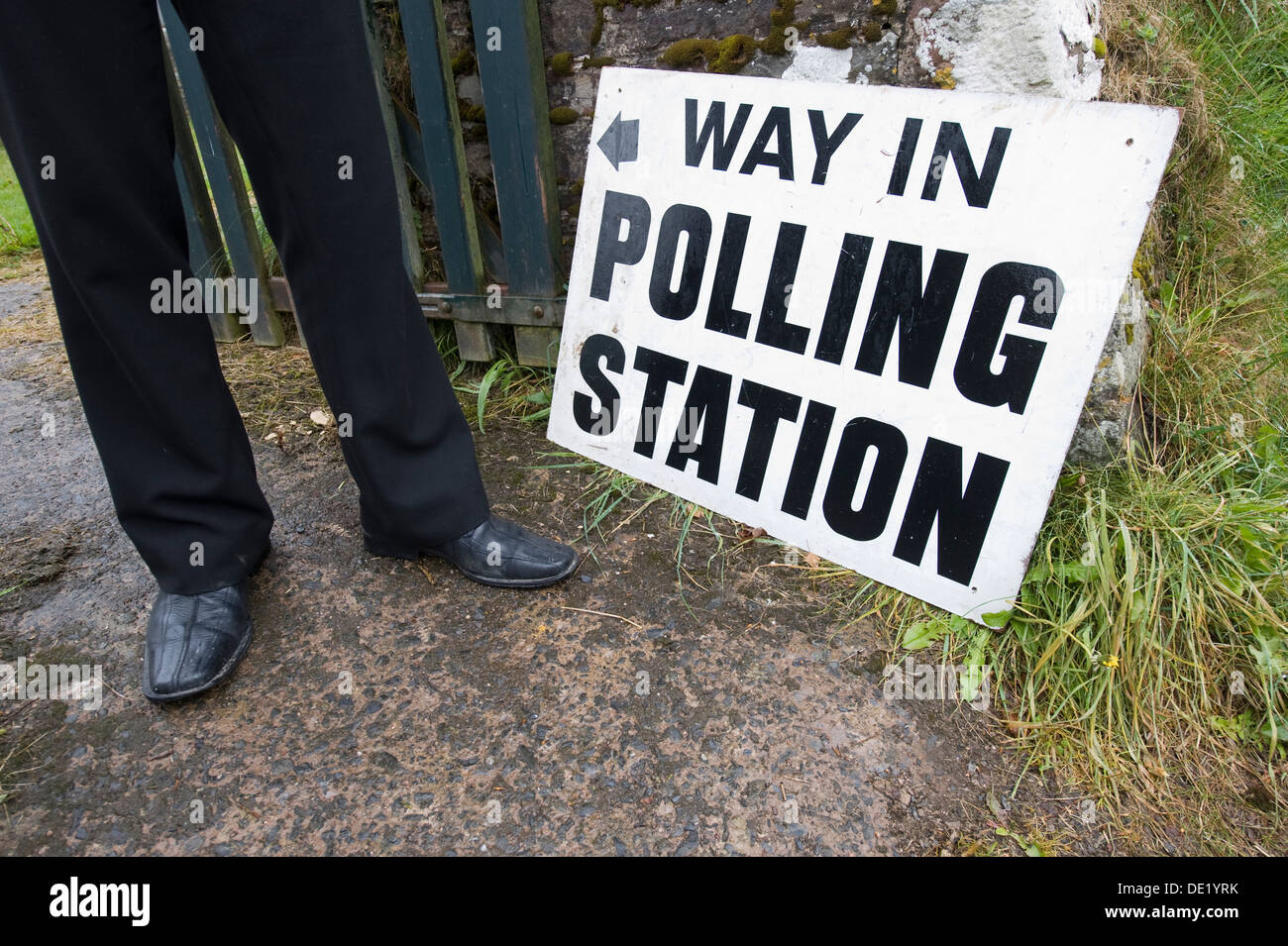 A voter stands outside a rural polling station at Stoke Rivers in North Devon Stock Photo