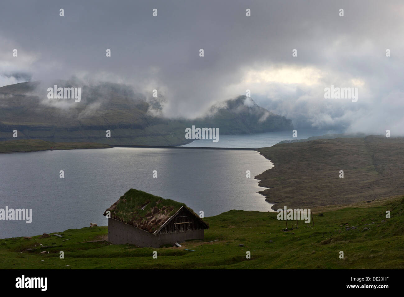 Hut at Eidisvatn lake, low clouds, Eysturoy, Faroe Islands, Denmark Stock Photo