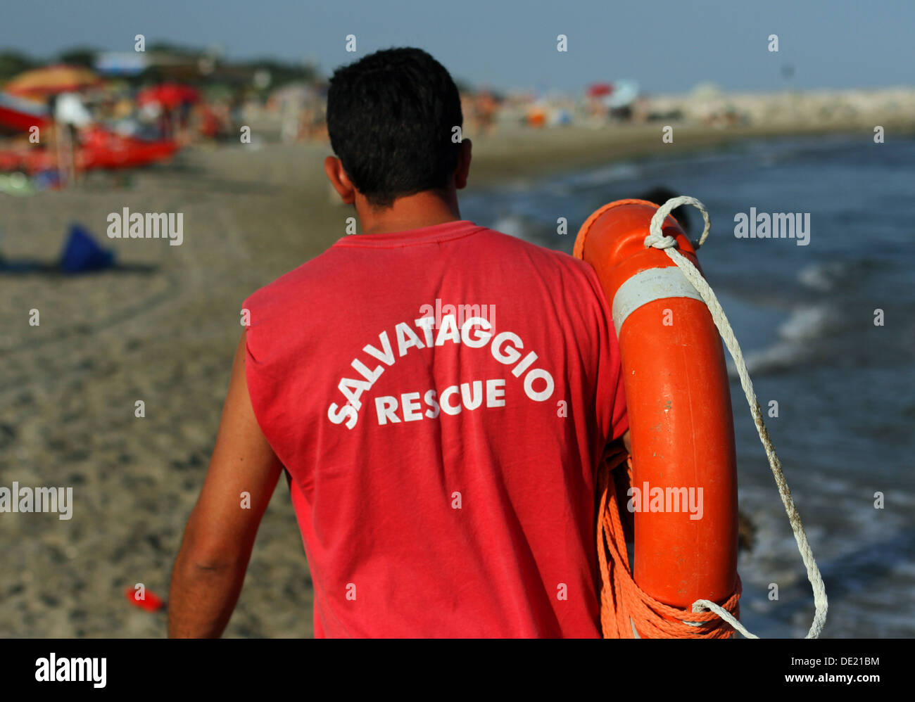 Lifeguard with red uniform for the rescue of swimmers in the sea with lifebuoy Stock Photo
