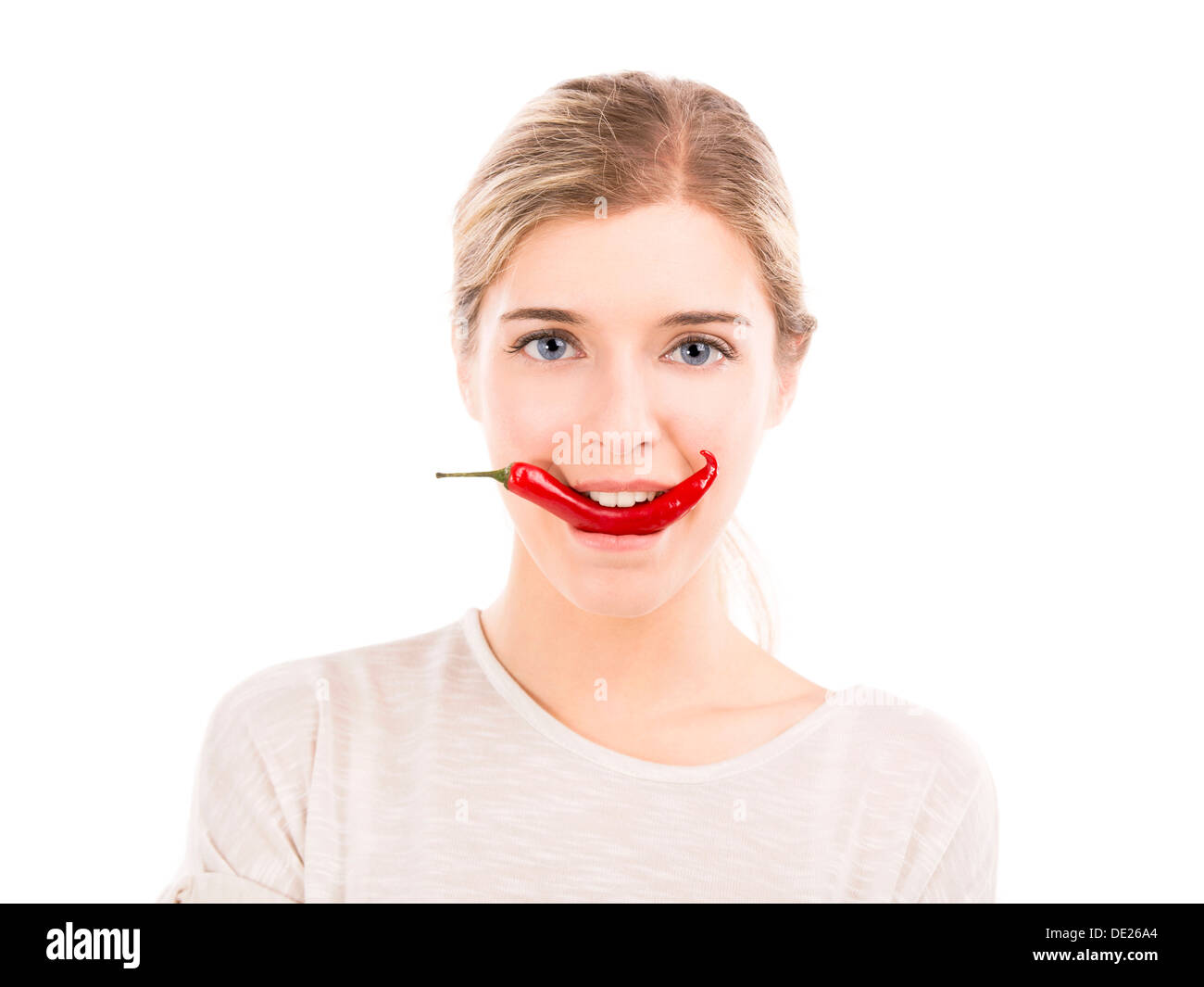 Beautiful girl biting a red chili pepper, isolated over a white background Stock Photo