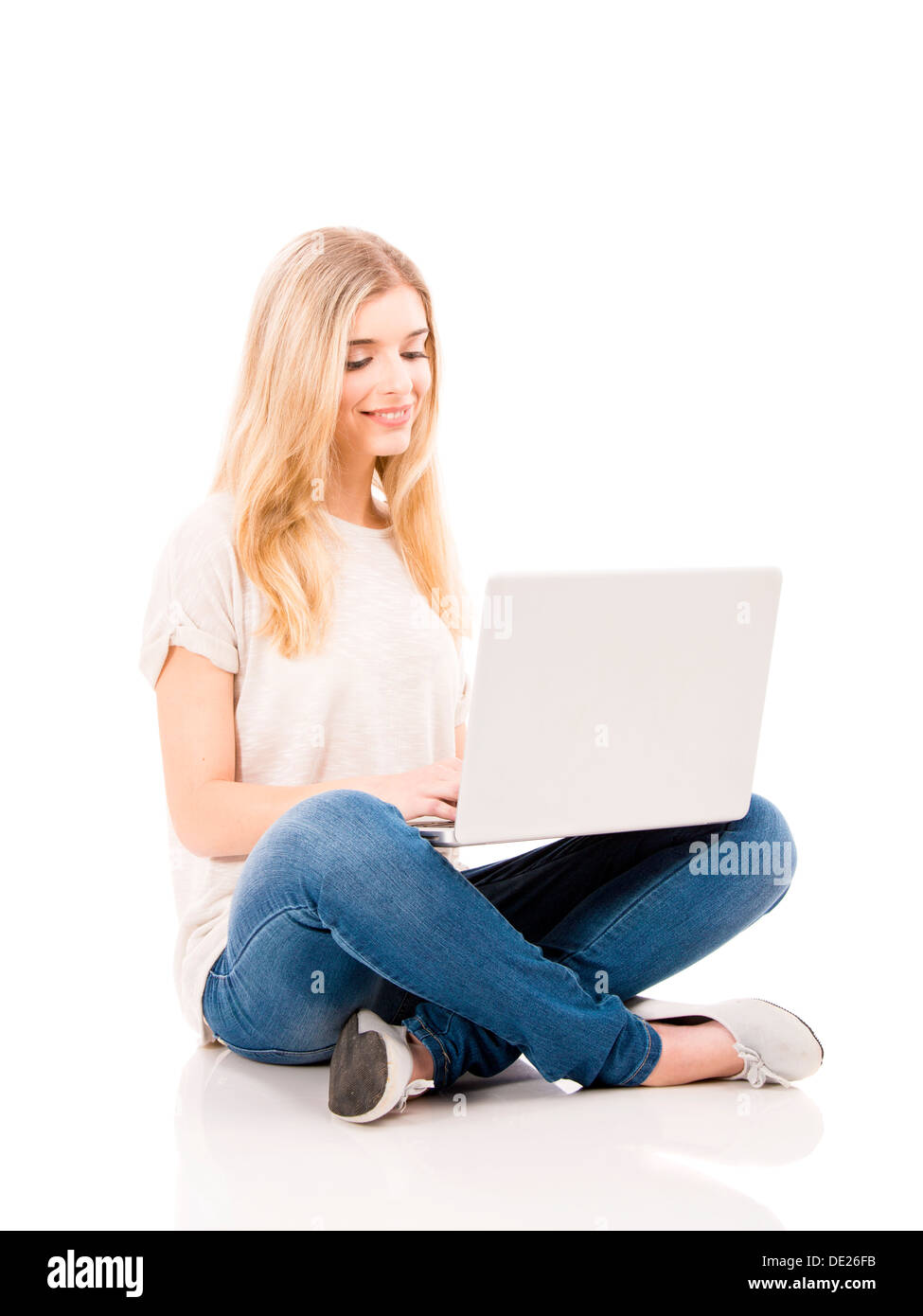 Beautiful and happy woman working with a laptop, isolated over white ...