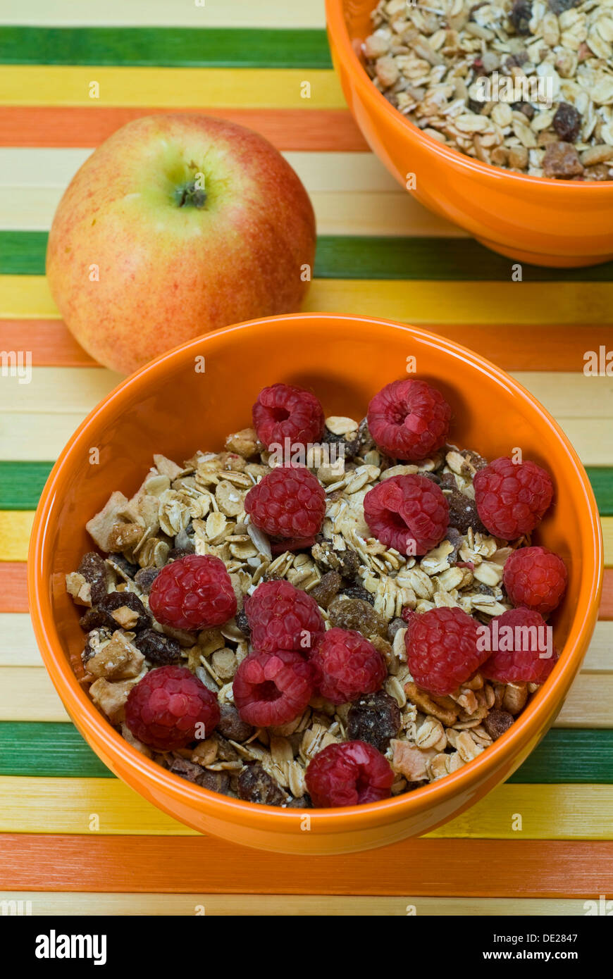 Fruit muesli with raspberries and an apple Stock Photo