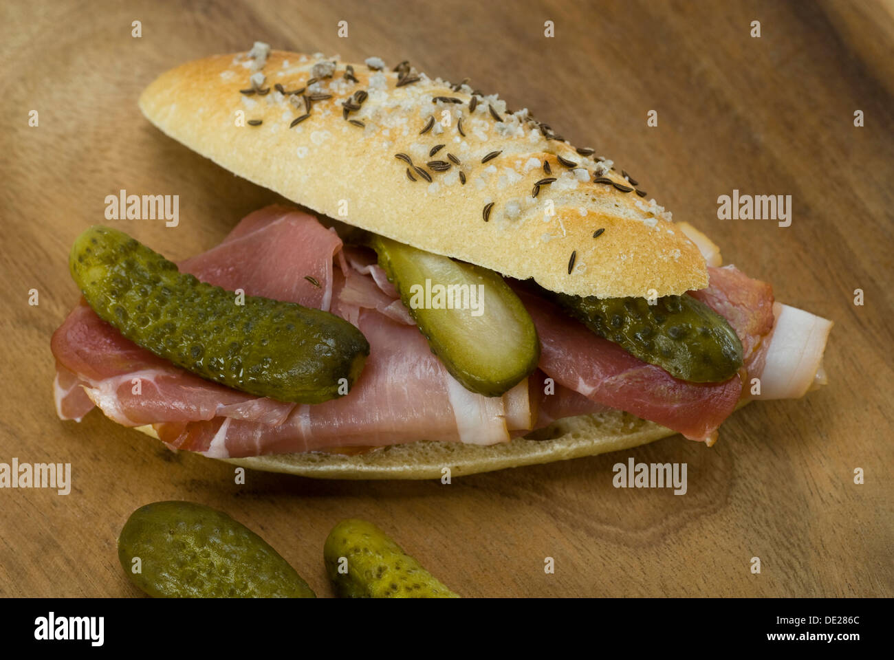 Salted roll with ham and pickles Stock Photo