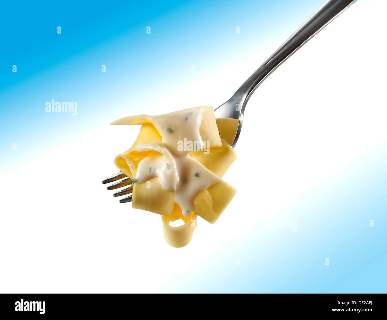 Tagliatelle pasta on a fork with gorgonzola sauce Stock Photo