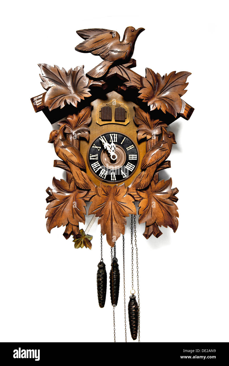 Classic wood-carved Black Forest cuckoo clock, the hands are stopped at eleven fifty-five, Germany Stock Photo