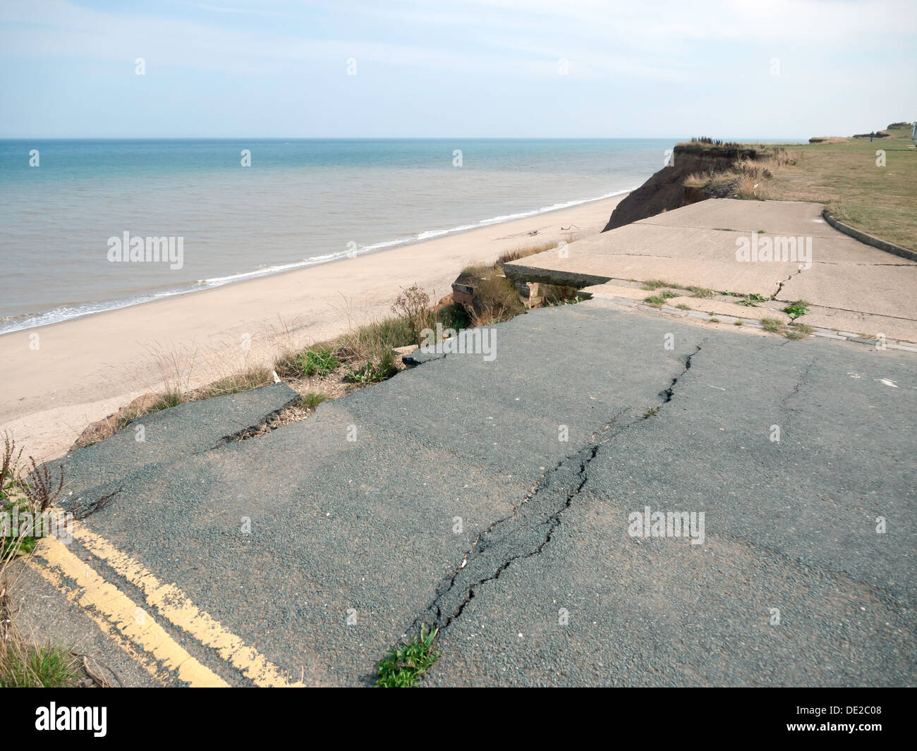 The cliff edge end of a road closed by coastal erosion in North Yorkshire England Stock Photo