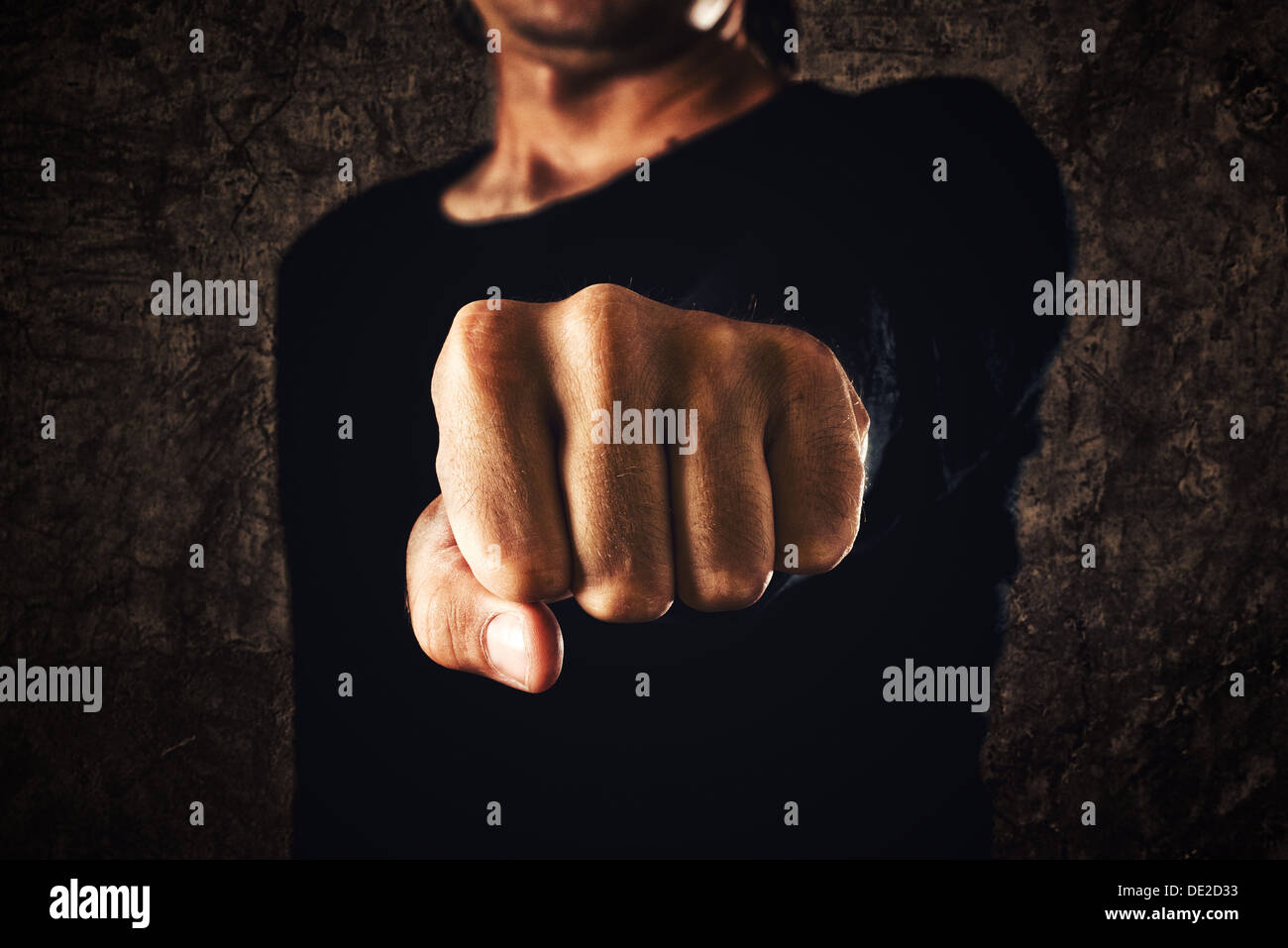 Hand with clenched fist on dark background. Power, determination, resistance concept. Stock Photo