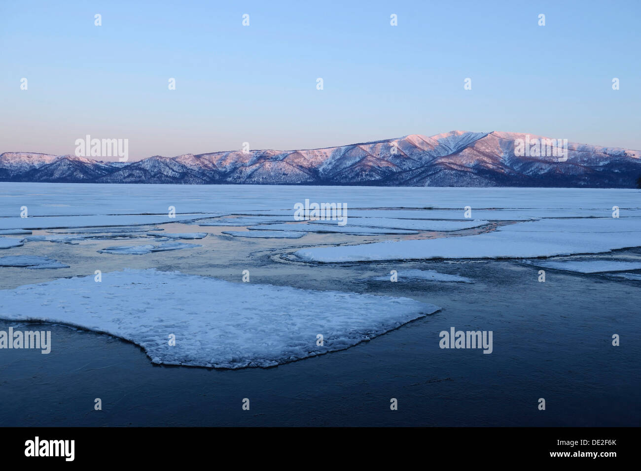 Early morning mood on the frozen Lake Kussharo with ice floes in the ...