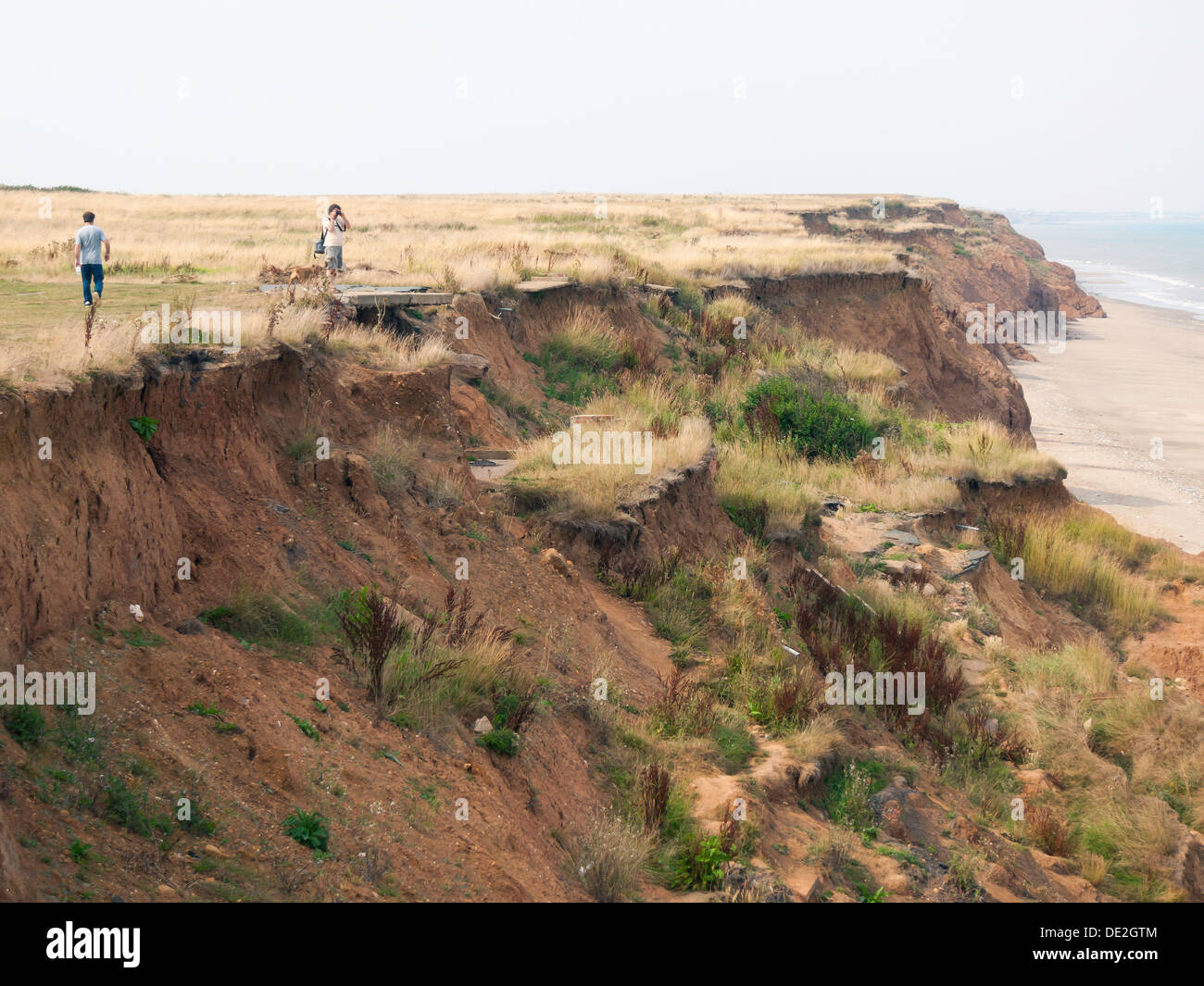 The cliff edge end of a road closed by coastal erosion in North Yorkshire England Stock Photo