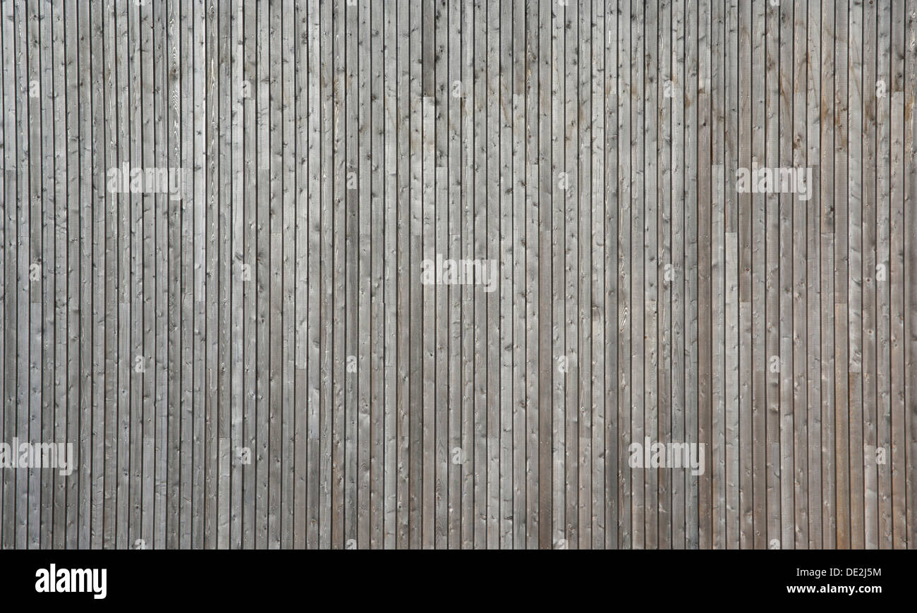 Faded, weathered wooden wall of planed boards Stock Photo
