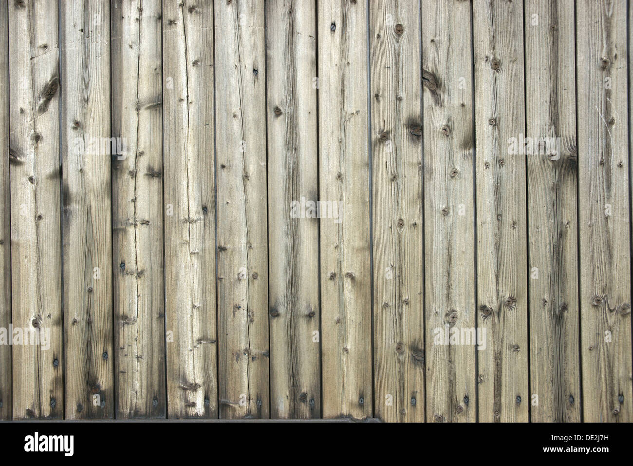 Faded wooden wall of planed boards Stock Photo