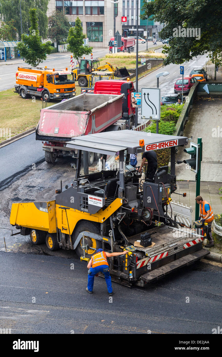 Innercity road construction site. Asphalted work on a major road