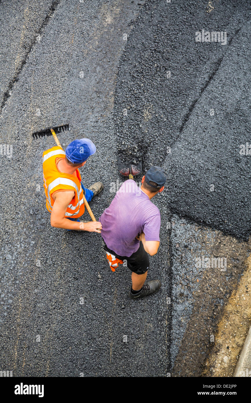 Innercity road construction site. Asphalted work on a major road