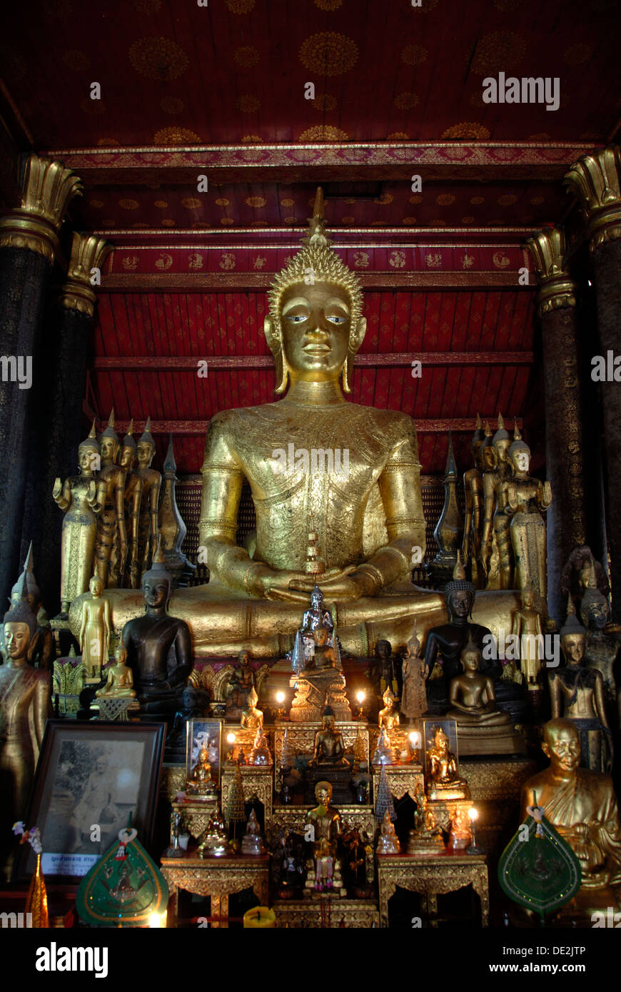 Theravada Buddhism, big old golden Buddha statue with many small ...