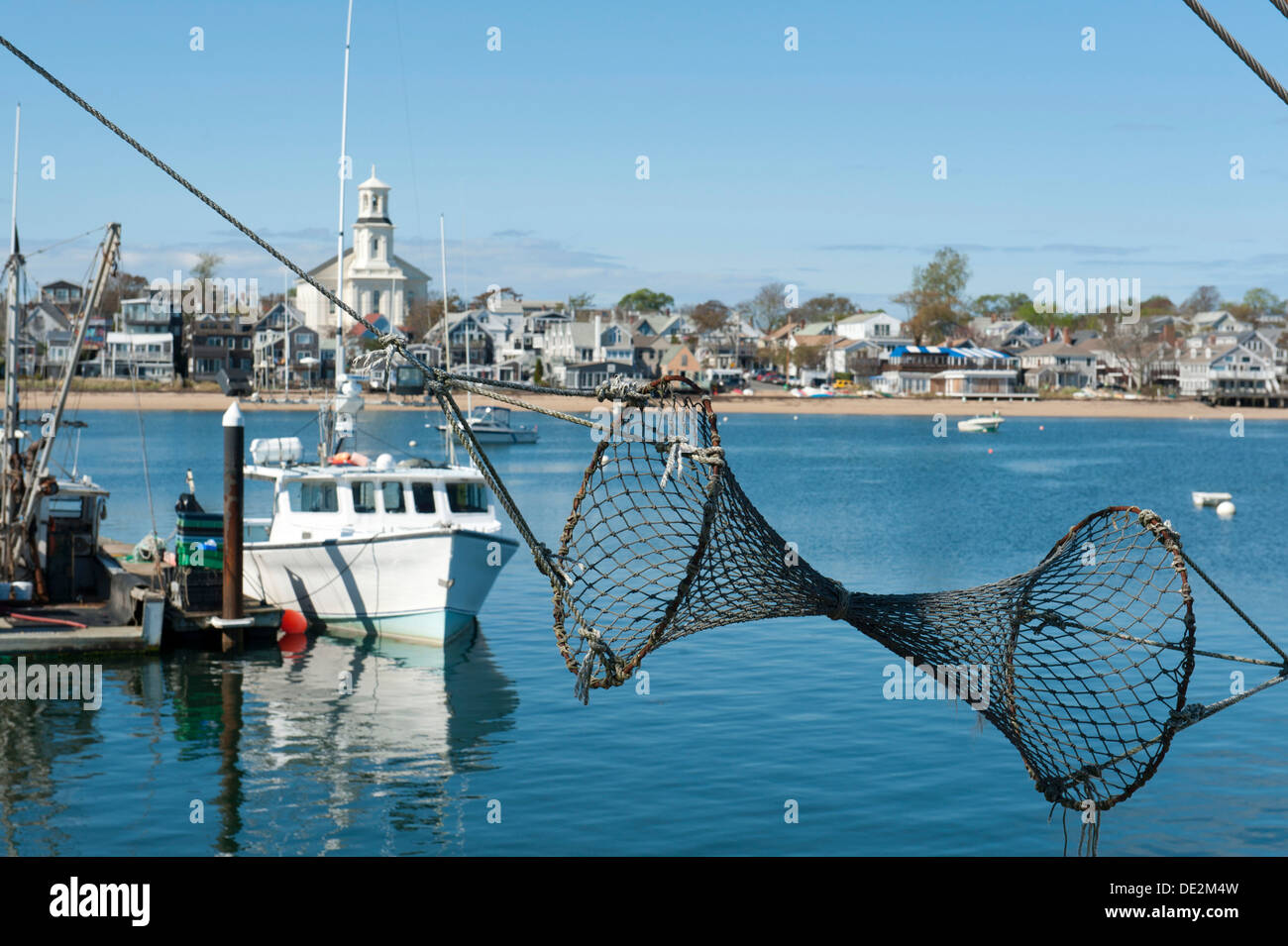 View from the pier past a fishing net and fishing boat towards boats and  the city, Provincetown, Cape Cod, Massachusetts, USA Stock Photo - Alamy