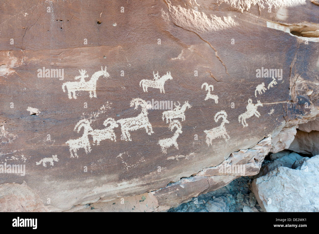 Petroglyphs of the Ute Indians, animals and riders on horseback carved in a rock, Arches National Park, Utah Stock Photo