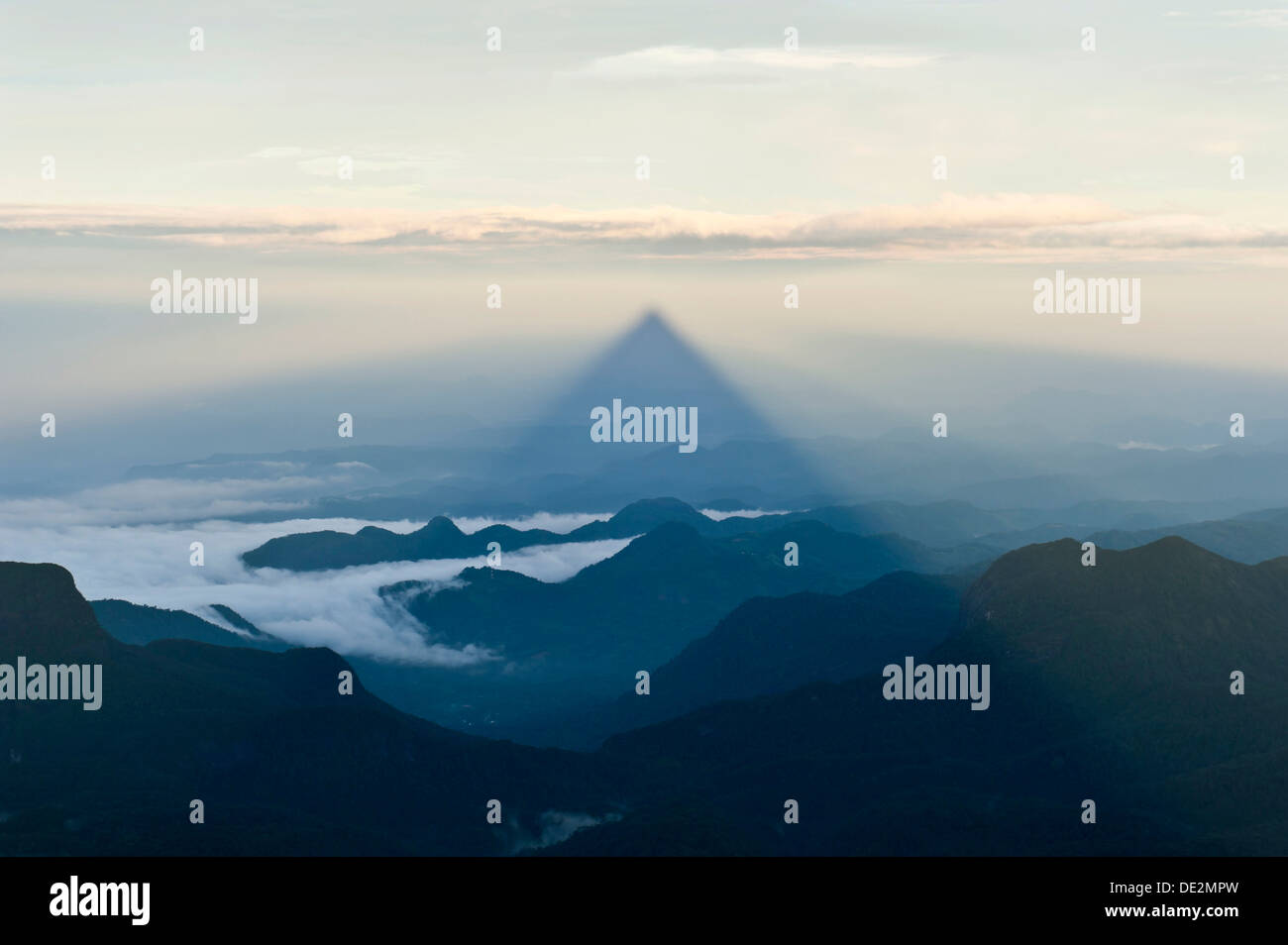 Pilgrim mountain, sun creating a triangle shadow in the landscape, image of God, Buddhist temple, Adam's Peak, Sri Pada Stock Photo