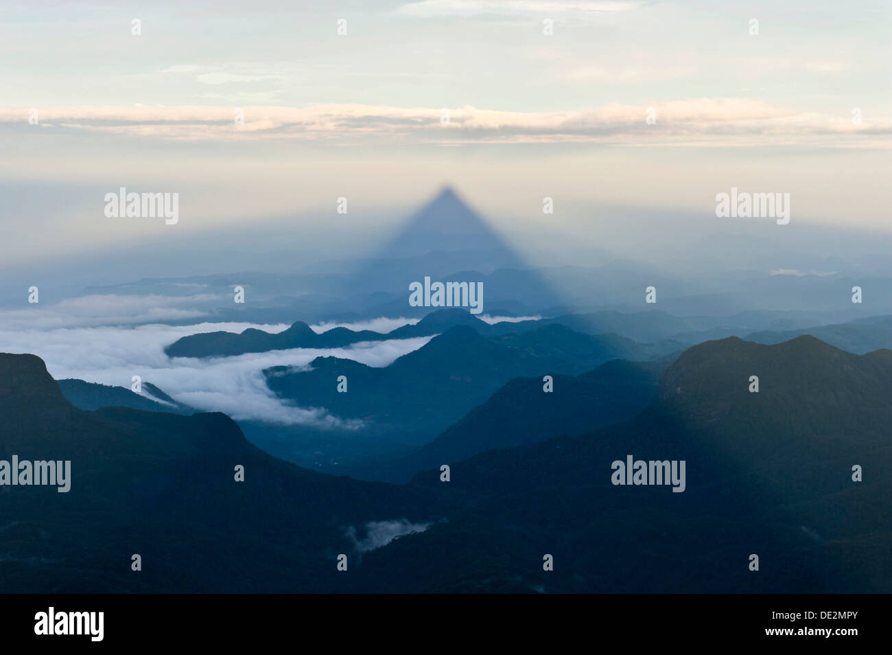 Pilgrim mountain, sun creating a triangle shadow in the landscape, image of God, Buddhist temple, Adam's Peak, Sri Pada Stock Photo