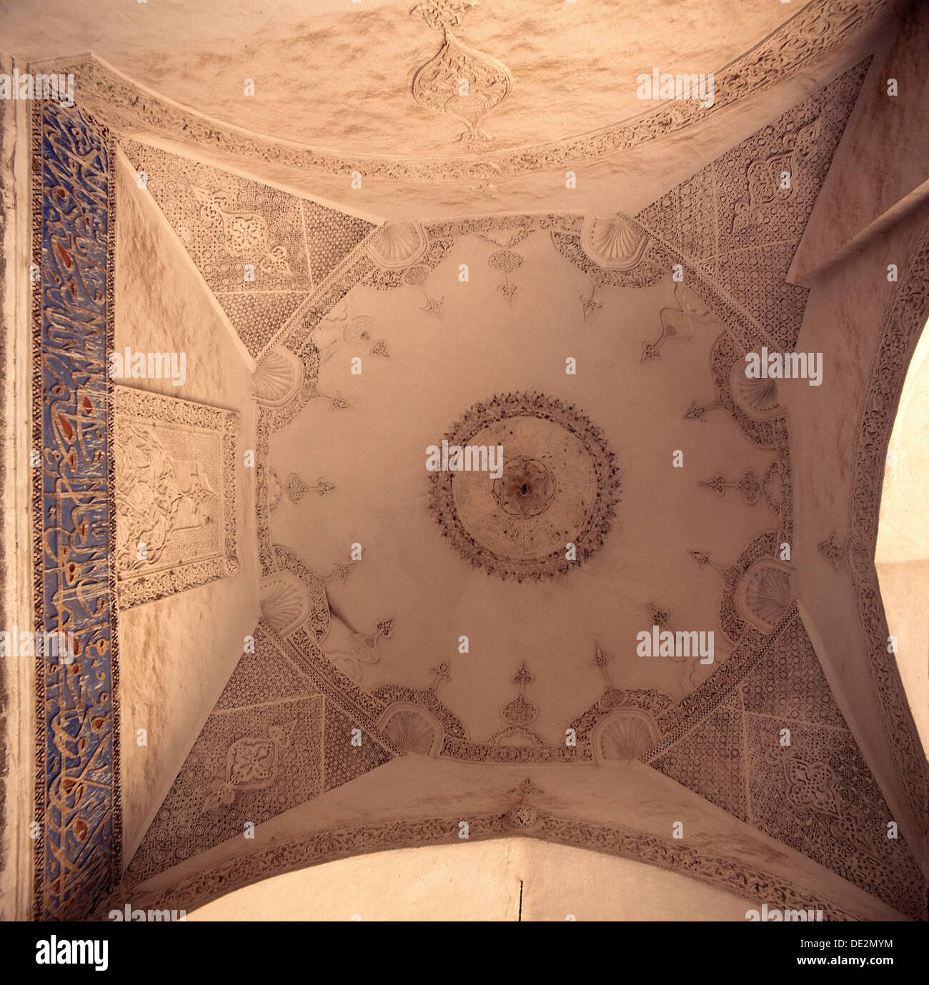Plaster ceiling incised with geometric designs and freize of Arabic calligraphy. Stock Photo