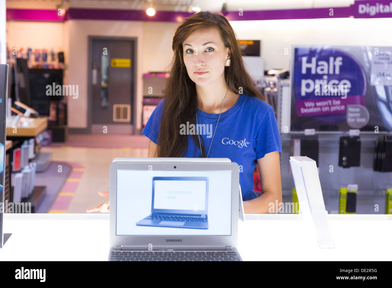 Google specialist at a computer store  demonstrating a Google Chromebook based laptop computer Stock Photo