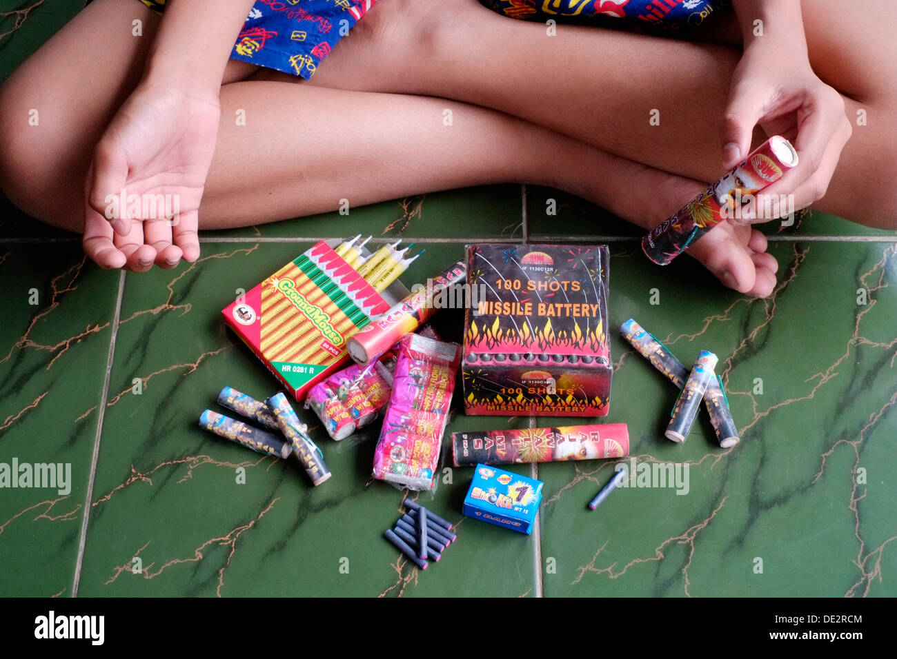 young indonesian boy with his collection of fireworks to celebrate the holidays with Stock Photo